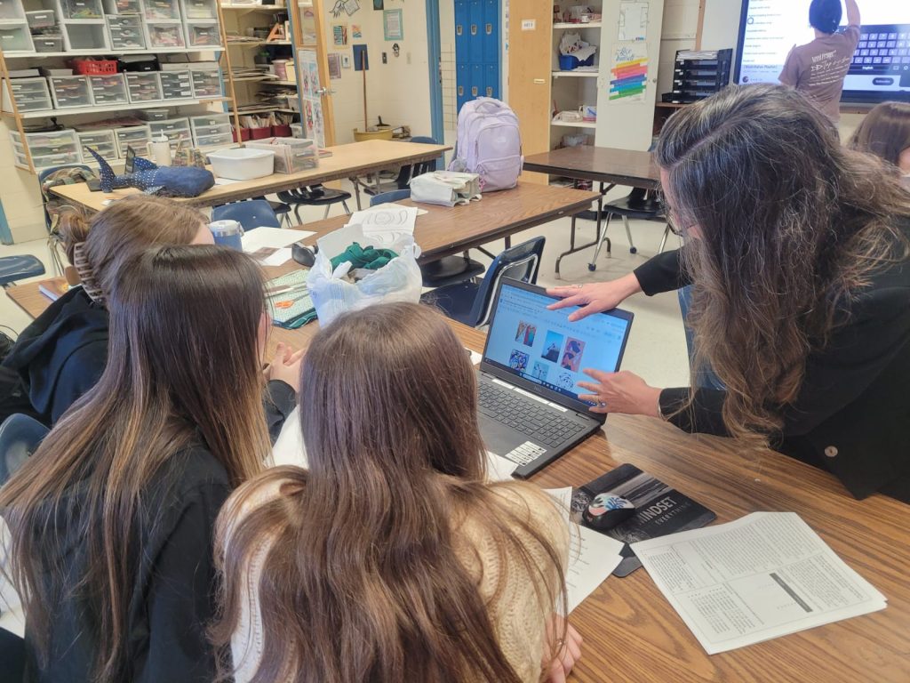 Students and Mrs. Fun reviewing project