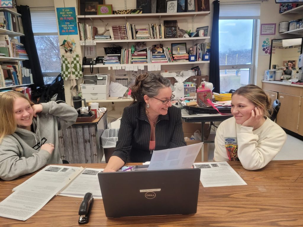 Mrs. Fun and students reviewing "A Positive Message" Project Plan